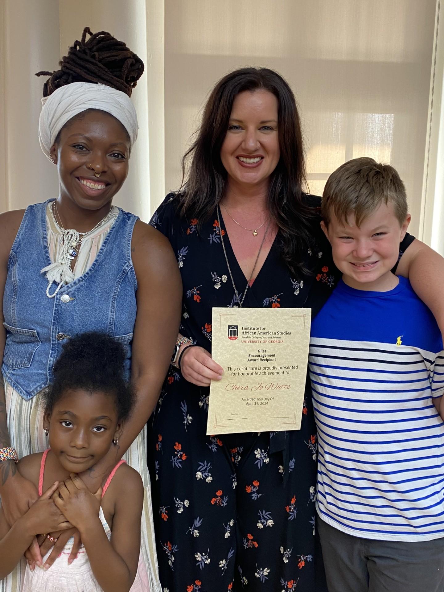 Graduate award winner Chera Jo Watts, Dr. Sha'Mira Covington, and their little ones